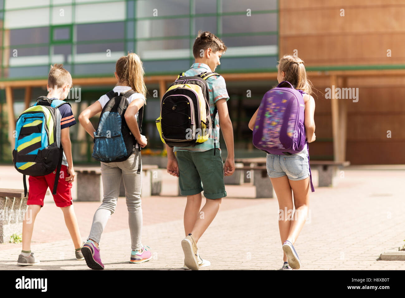 group of happy elementary school students walking Stock Photo - Alamy