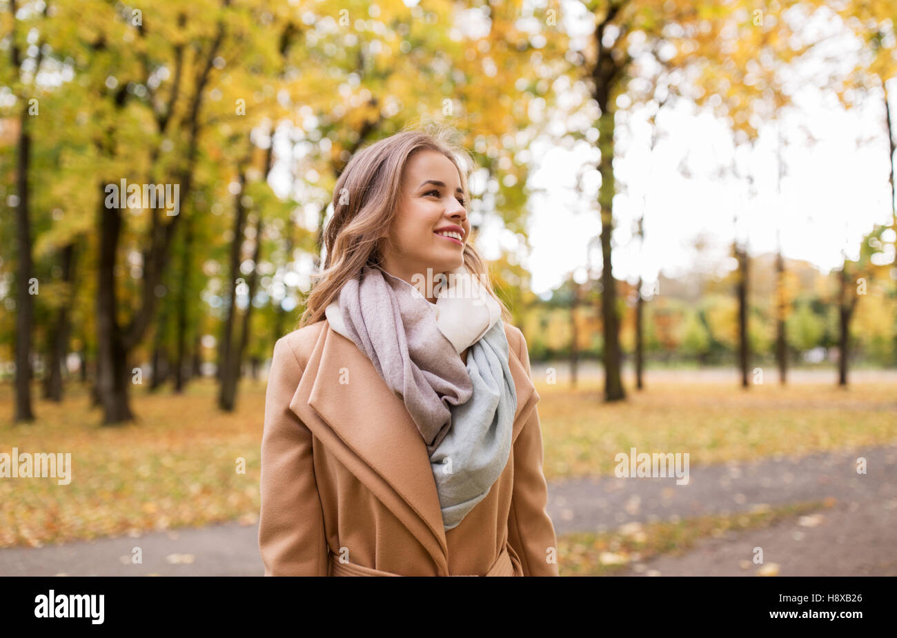 beautiful happy young woman walking in autumn park Stock Photo - Alamy
