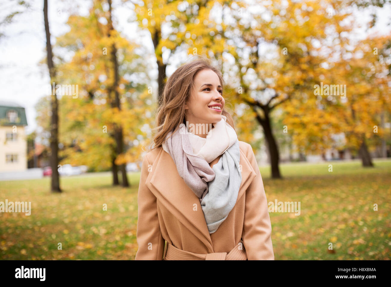beautiful happy young woman walking in autumn park Stock Photo - Alamy