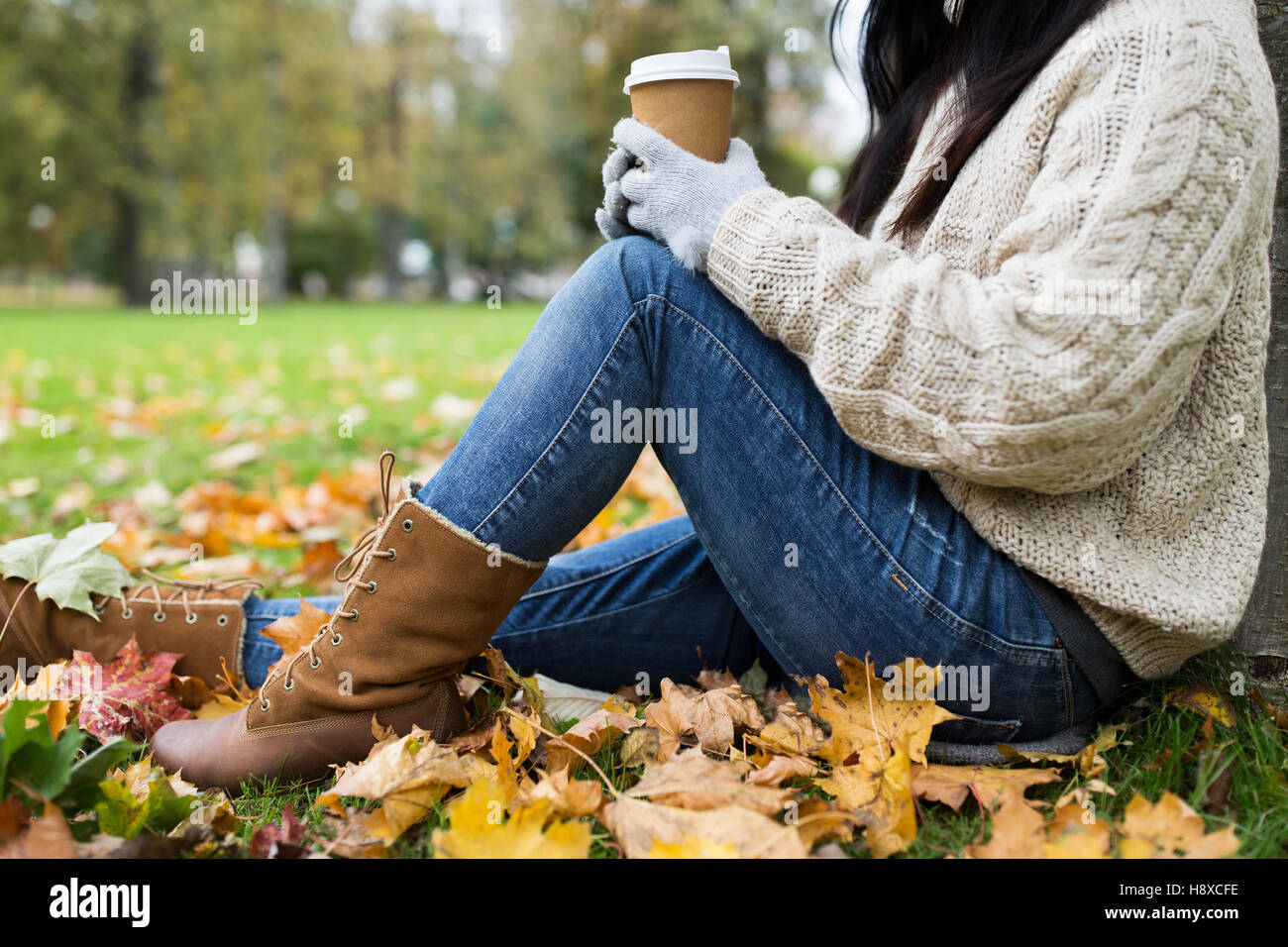 close up of woman drinking coffee in autumn park Stock Photo - Alamy