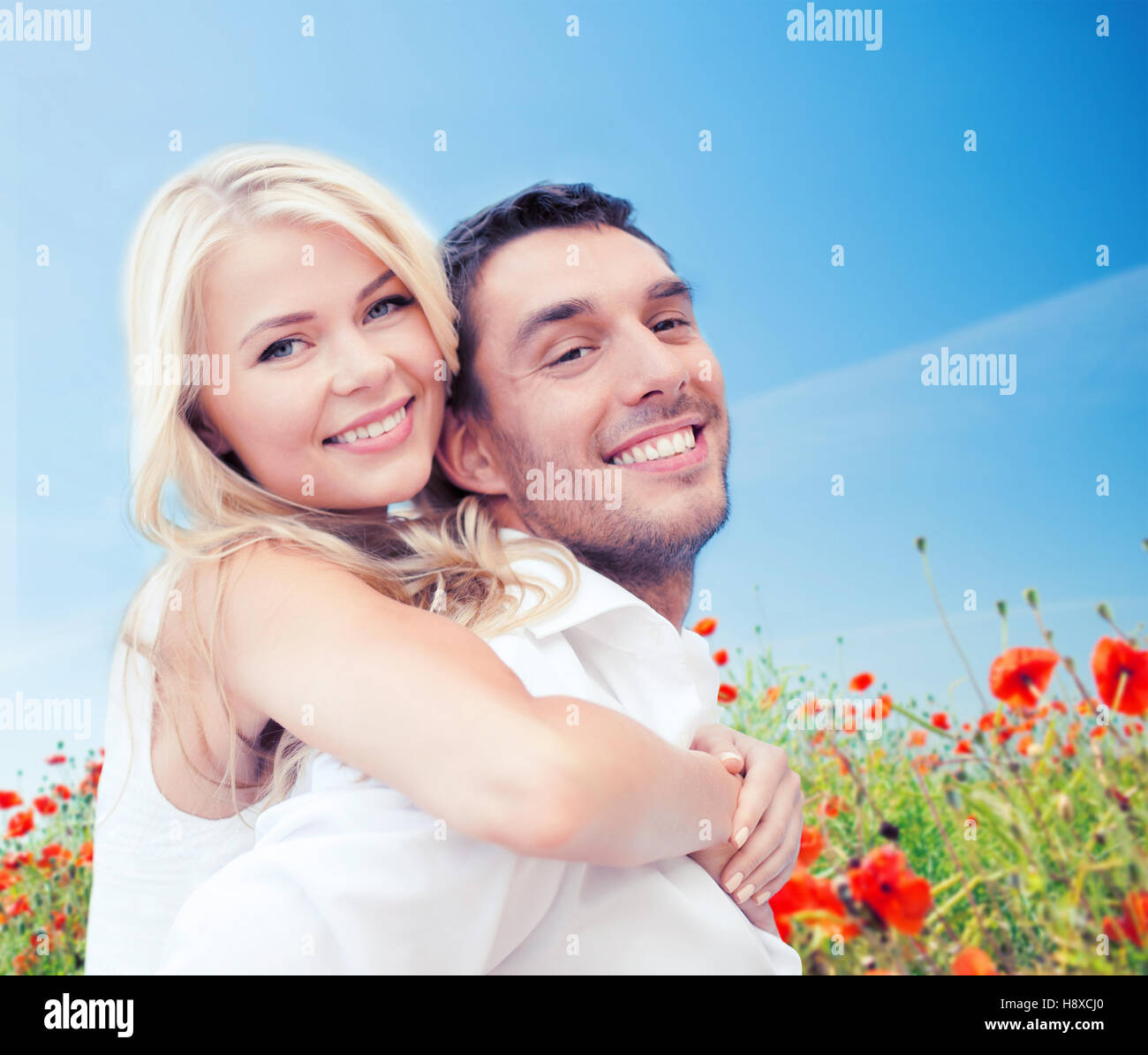 happy couple having fun over poppy flowers field Stock Photo - Alamy