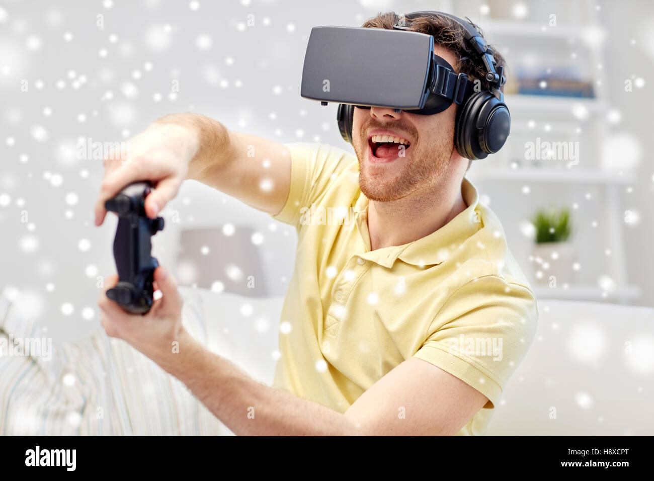 man in virtual reality headset with controller Stock Photo - Alamy