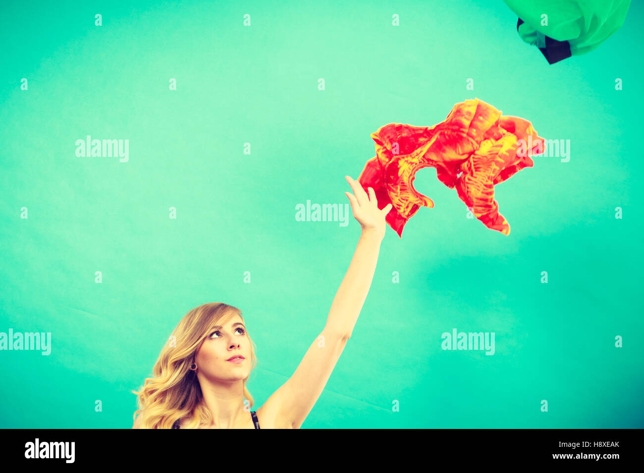 Cleaning in the closet, fashion, happiness concept. Woman throwing up