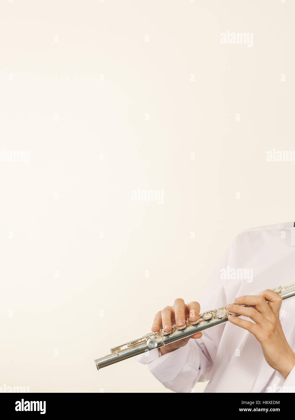 Flute music playing professional male flutist musician performer. Young elegant guy holding