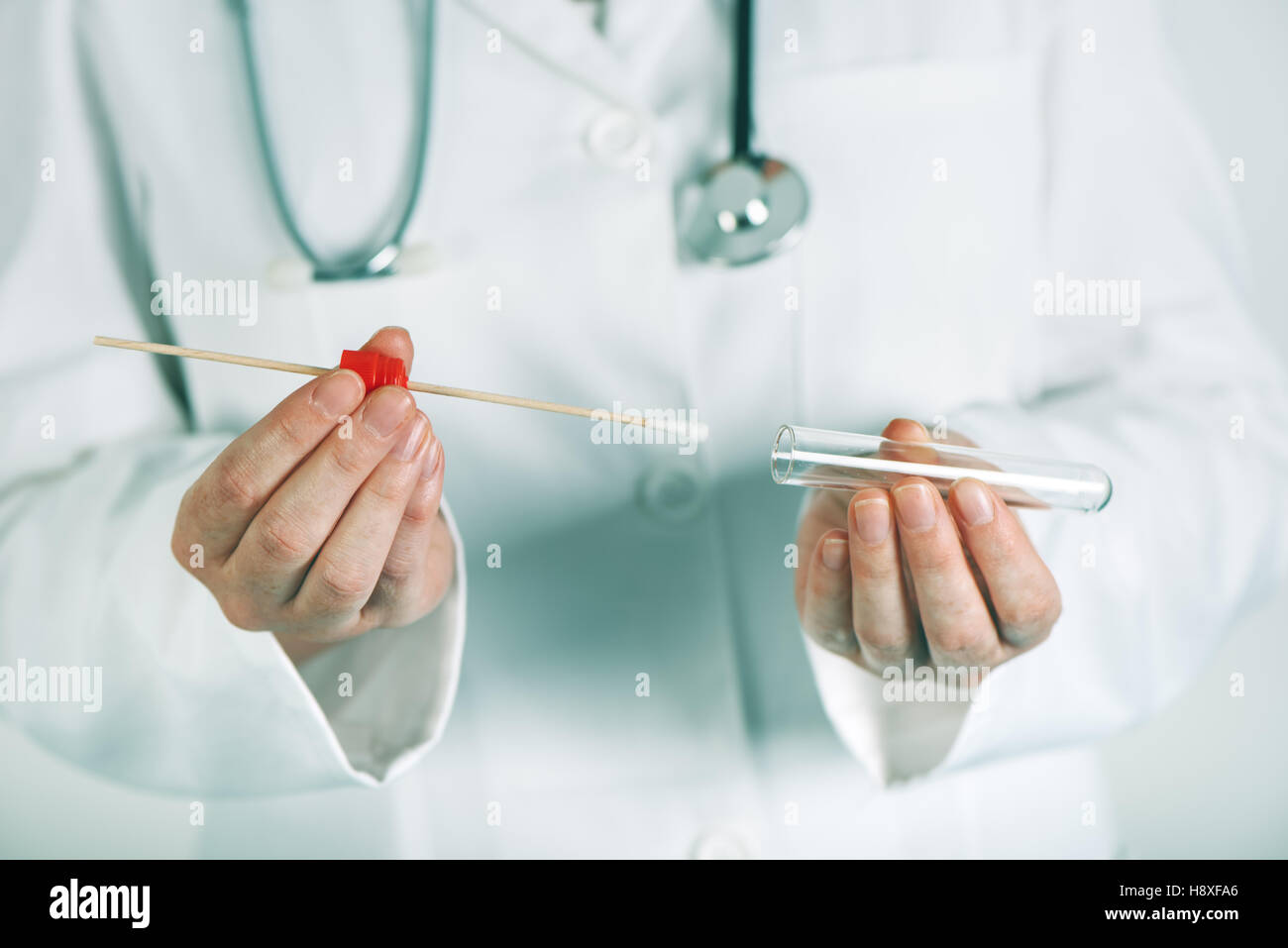 Female laboratory specialist holding test tube with cotton swab