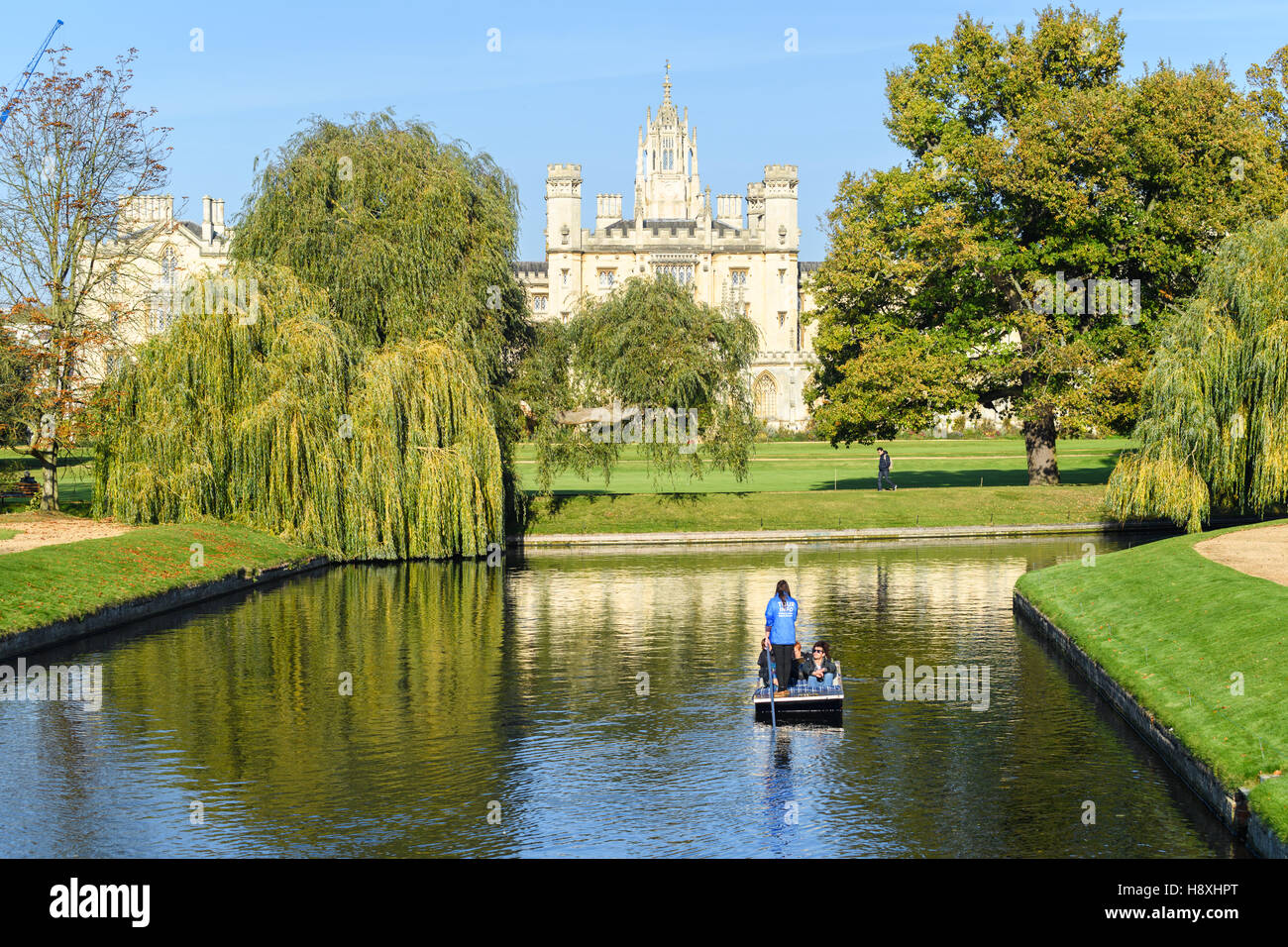 Punting along the river Cam in the Gardens of Trinity college, university of Cambridge, England, with St John's college in the background. Stock Photo