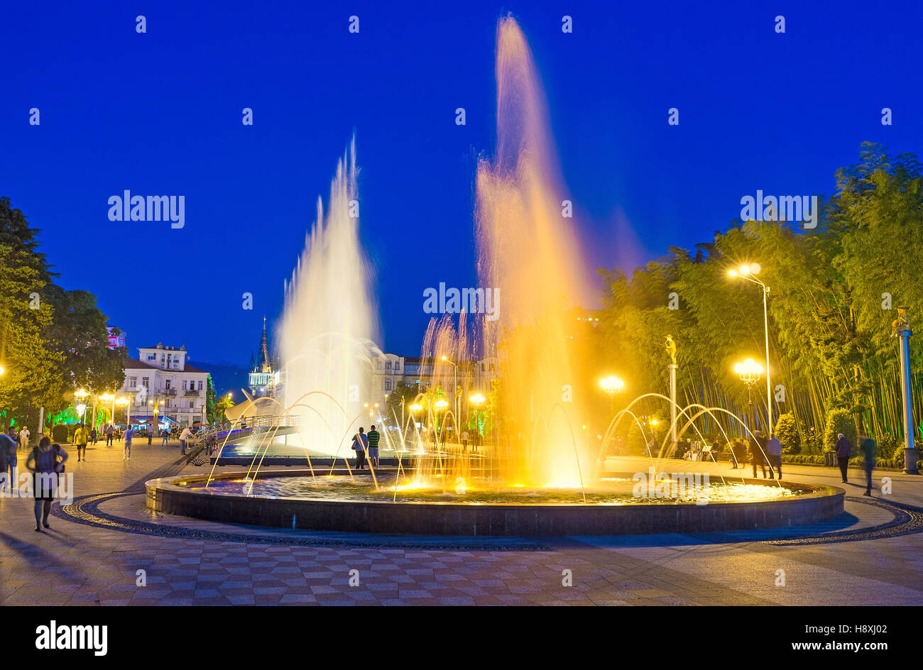 The evening performances of the singing and dancing french fountains are popular among the tourists, Batumi Stock Photo