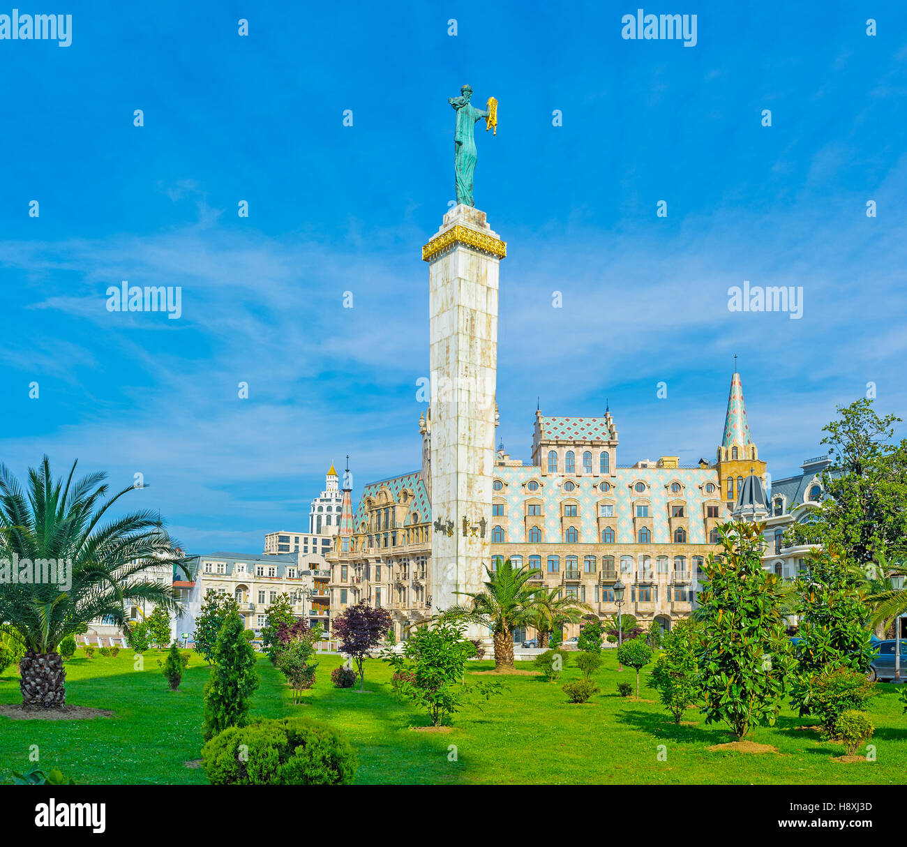 The bronze statue of Medea with the golden fleece rises over the mansions and greenery of Europe Square, Batumi, Georgia. Stock Photo