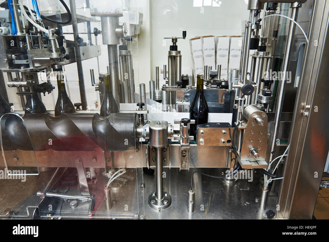 Labeling and sealing conveyor line at winery factory Stock Photo Alamy