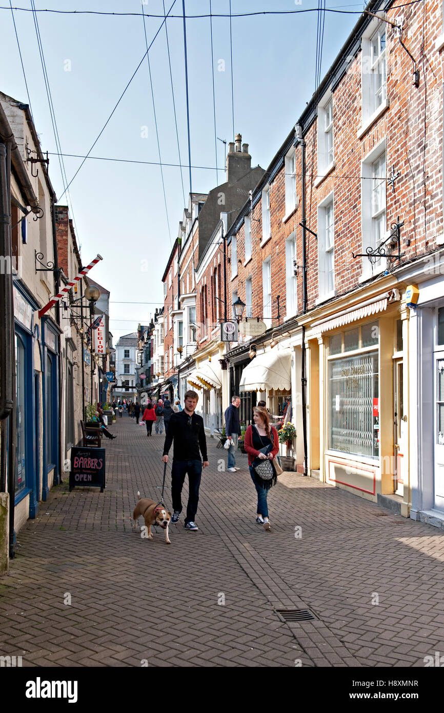Couple and dog walking in Bar Street, Scarborough, N. Yorks Stock Photo