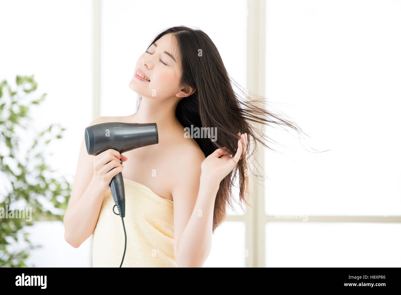 asian beauty woman hair dryer to drying hair after shower, indoors Stock Photo 125978054 Alamy