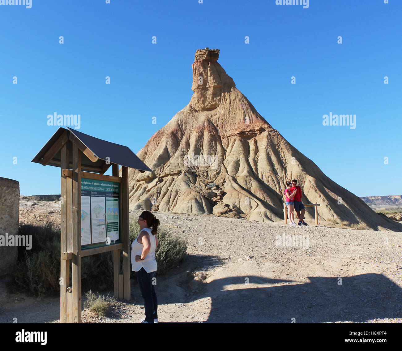 BARDENAS REALES, NAVARRE/SPAIN - AUGUST 16, 2014: Tourists at the Castildetierra landmark at the Bardenas Reales Natural Park. Stock Photo