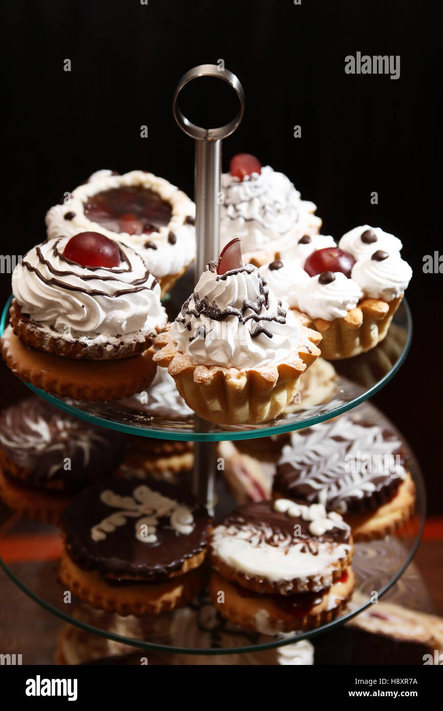 Set of various cakes on stand against dark background Stock Photo Alamy