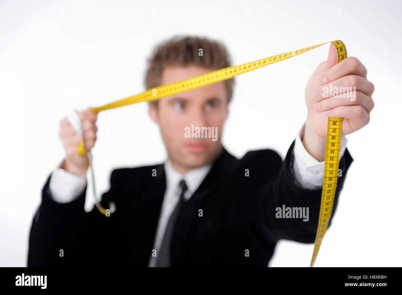 Businessman holding a measuring tape Stock Photo Alamy