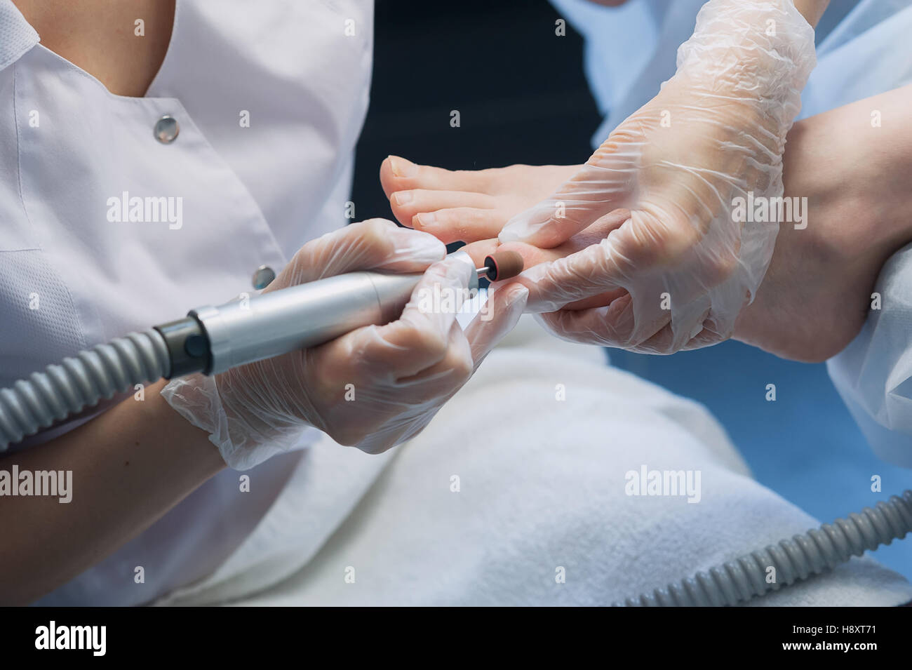 profesional nail technician sanding nails with machine Stock Photo Alamy