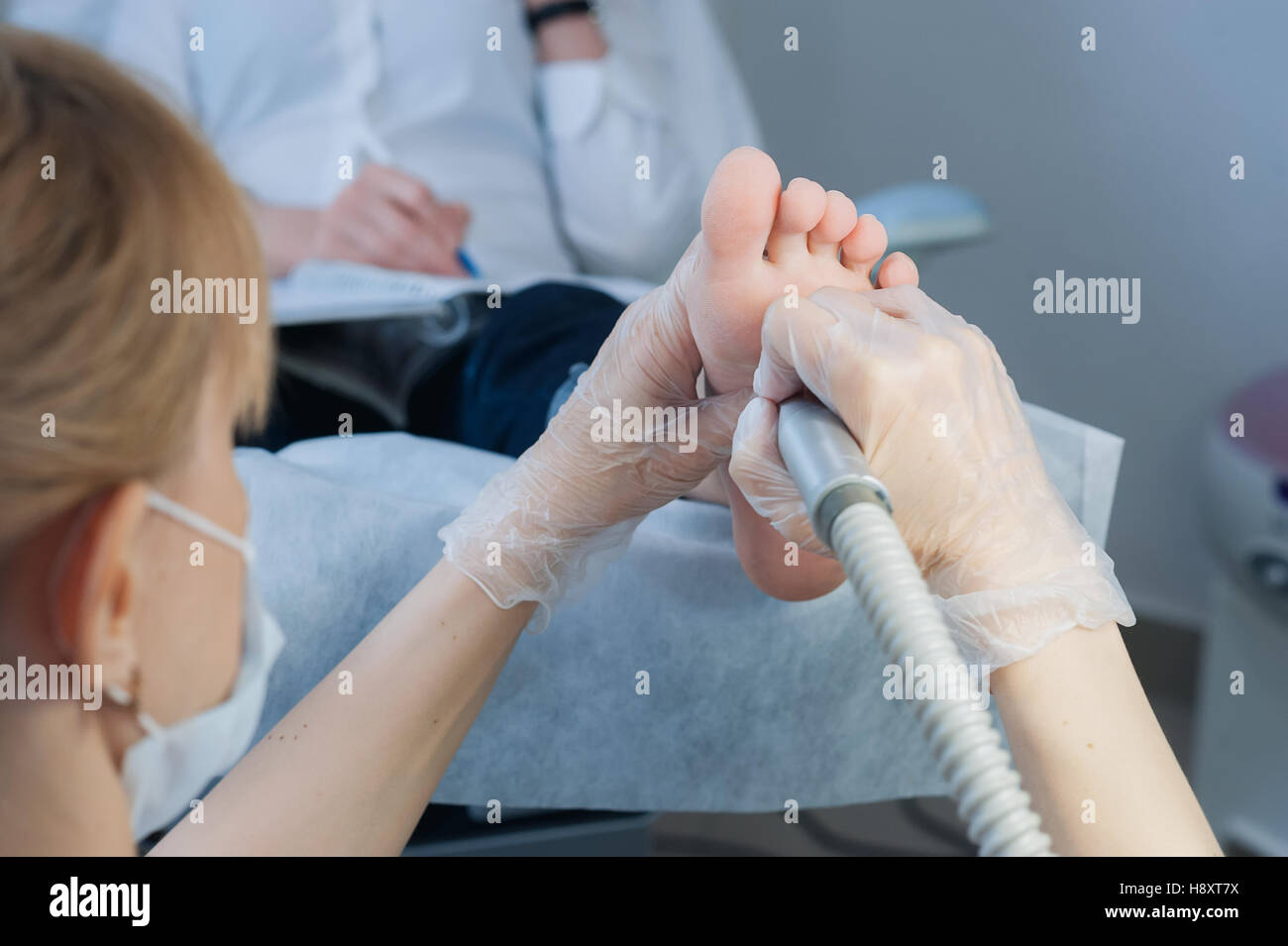 profesional nail technician sanding nails with machine Stock Photo Alamy