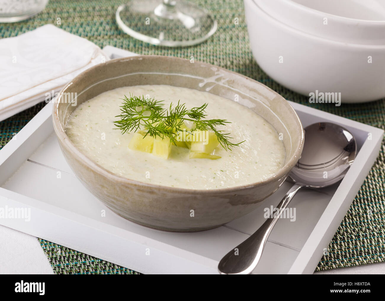 Delicious cold cucumber soup garnished with pieces of cucumber and dill. Stock Photo