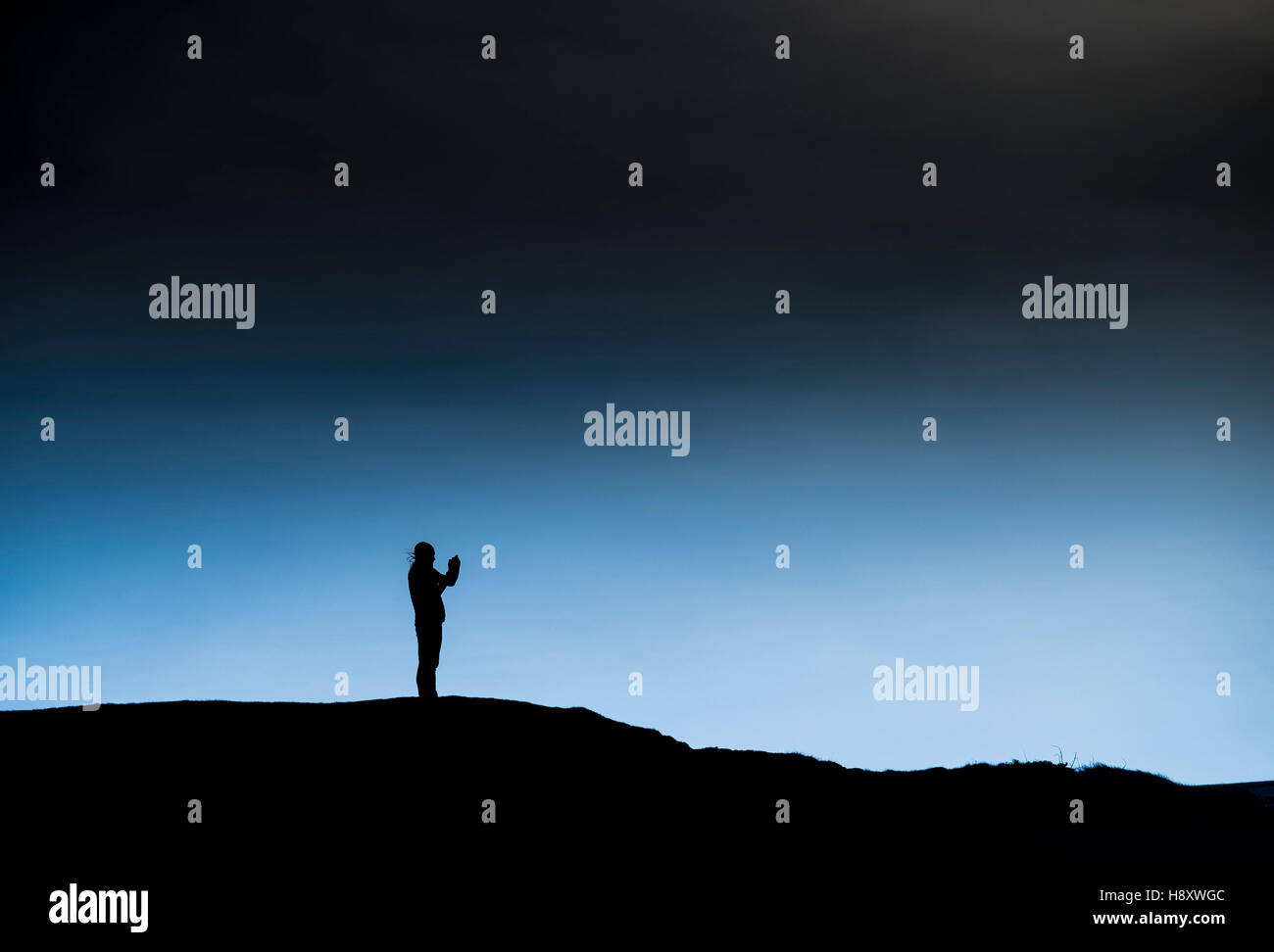 The silhouette of a man seen in early morning winter light. Stock Photo