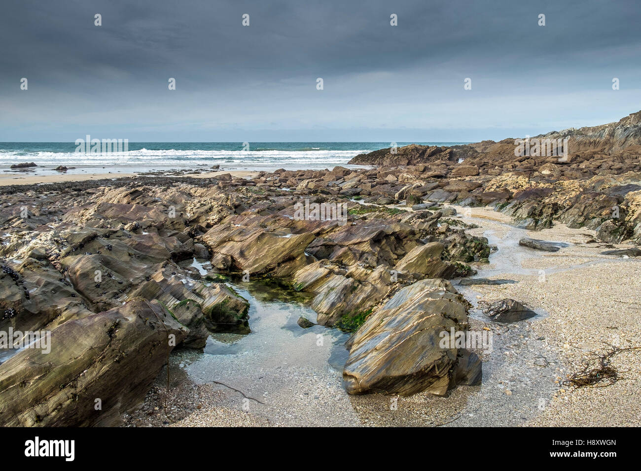 Rocks exposed at low tide on Little Fistral Beach in Newquay, Cornwall ...