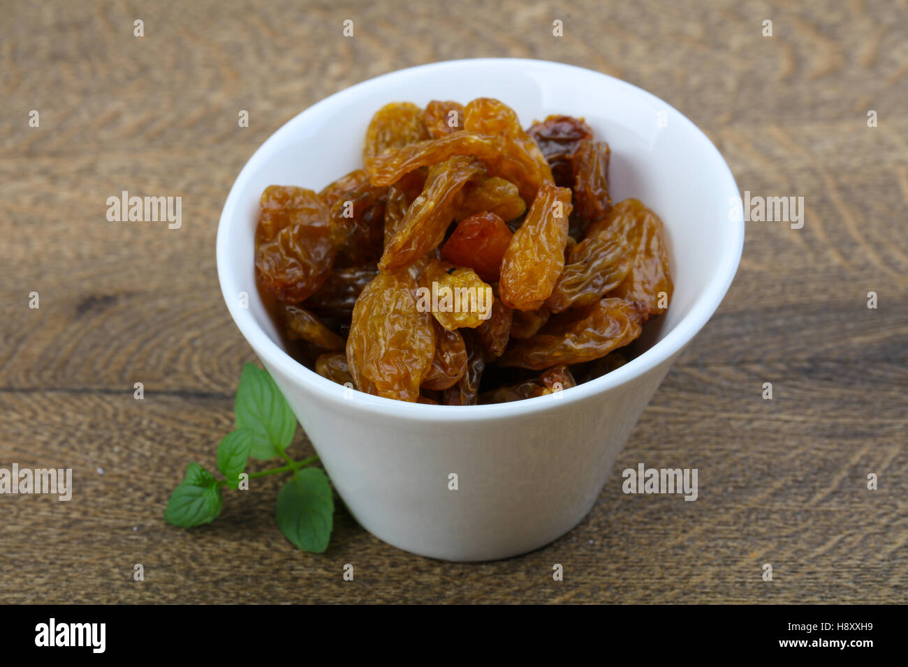 Sweet raisins in the bowl with mint leaves Stock Photo Alamy