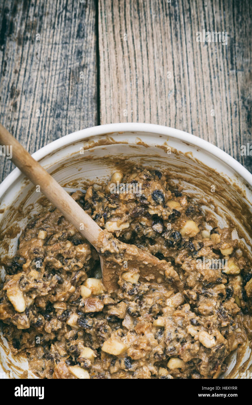 Christmas pudding mixture in a bowl with a wooden spoon. Stir up sunday Stock Photo