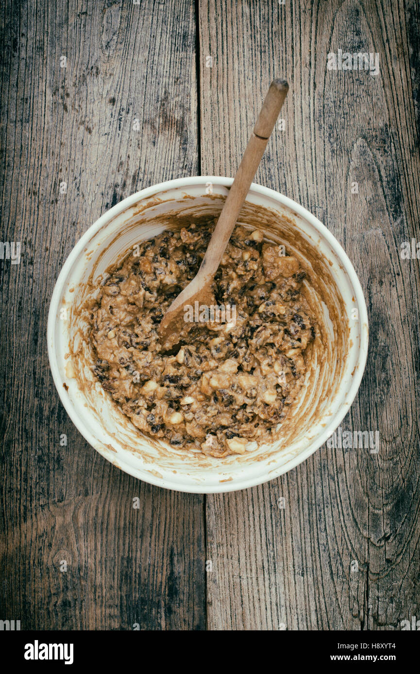Christmas pudding mixture in a bowl with a wooden spoon. Stir up sunday Stock Photo
