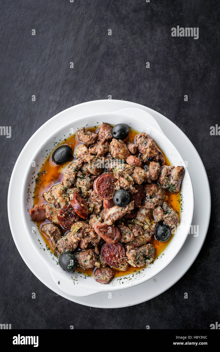 pica pau portuguese spicy sauce pork and sausage traditional tapas snack Stock Photo