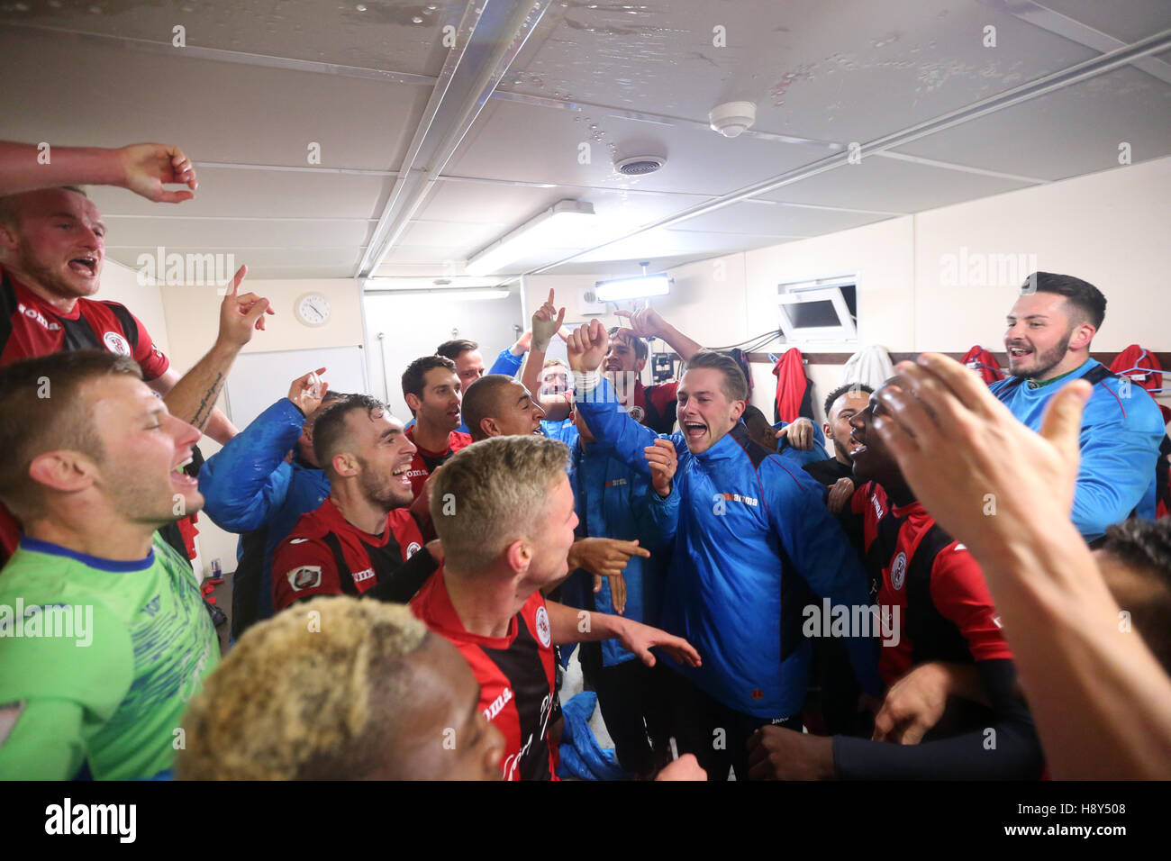 Brackley Town celebrate in the dressing room after the FA Cup First Round Replay at St James Park, Brackley. Stock Photo