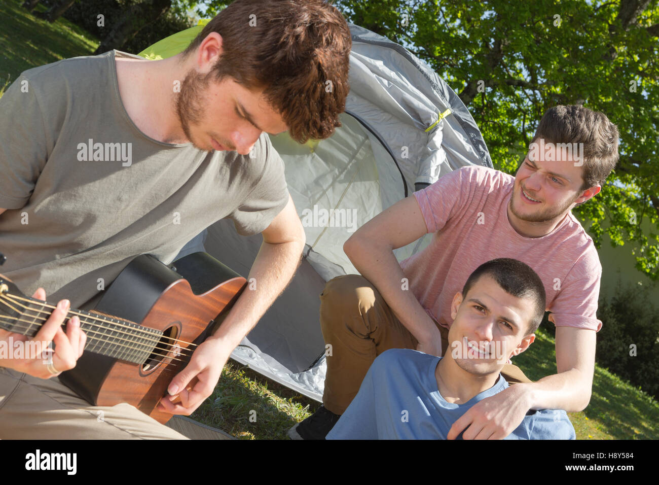 friends camping and playing guitar Stock Photo Alamy
