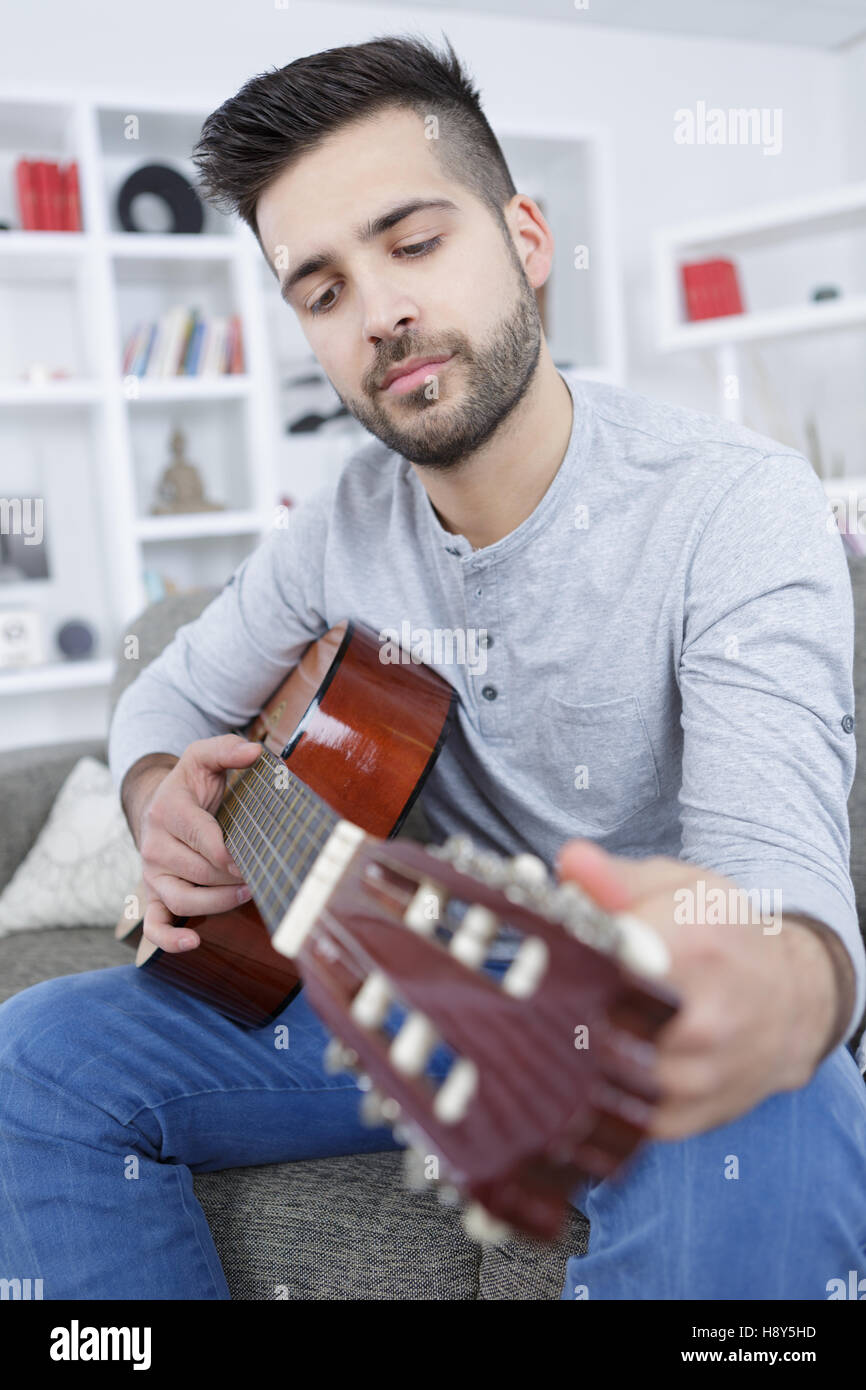 young man playing guitar at home Stock Photo - Alamy