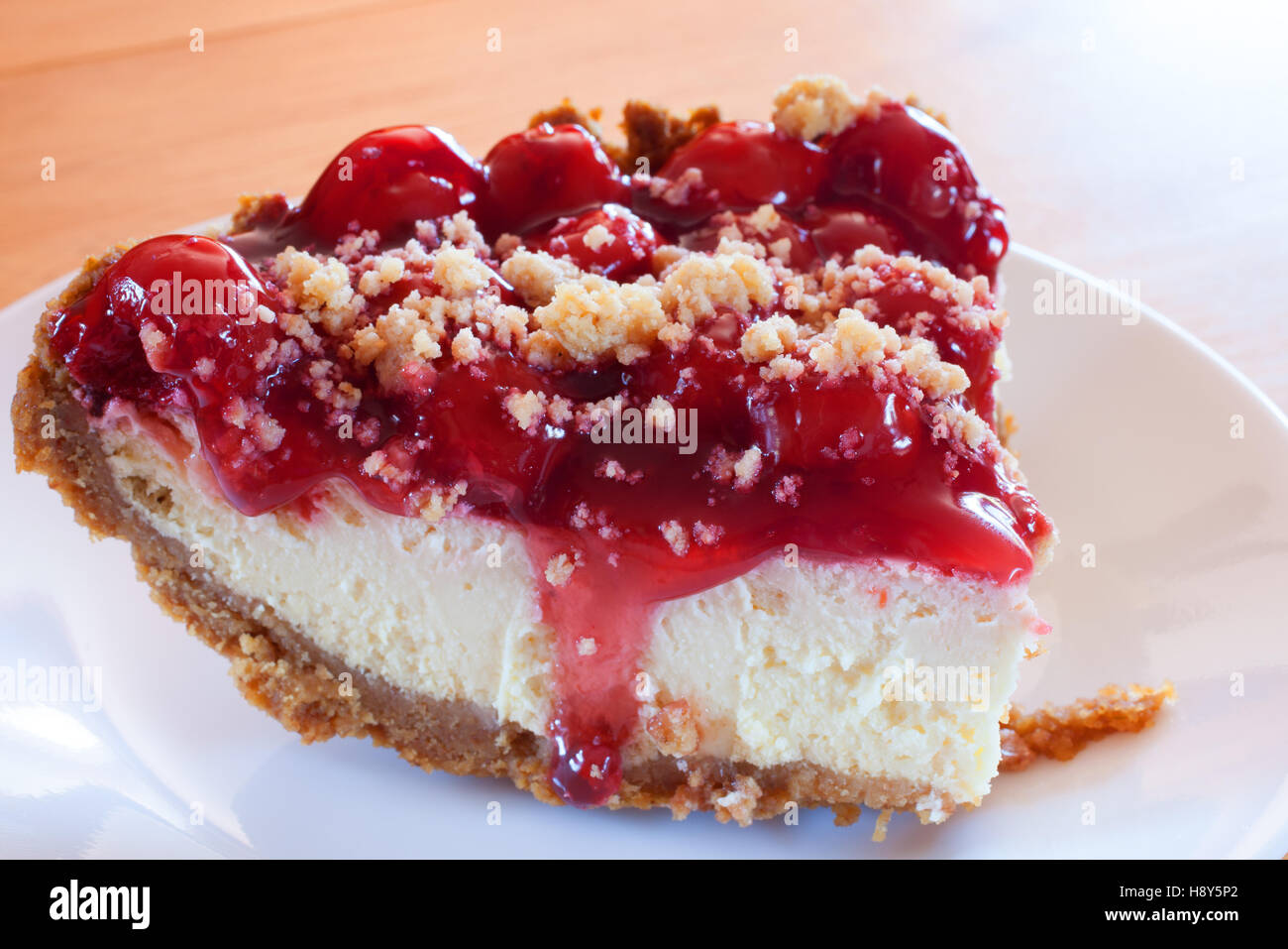 Cheesecake with a graham cracker crust and cherry topping Stock Photo