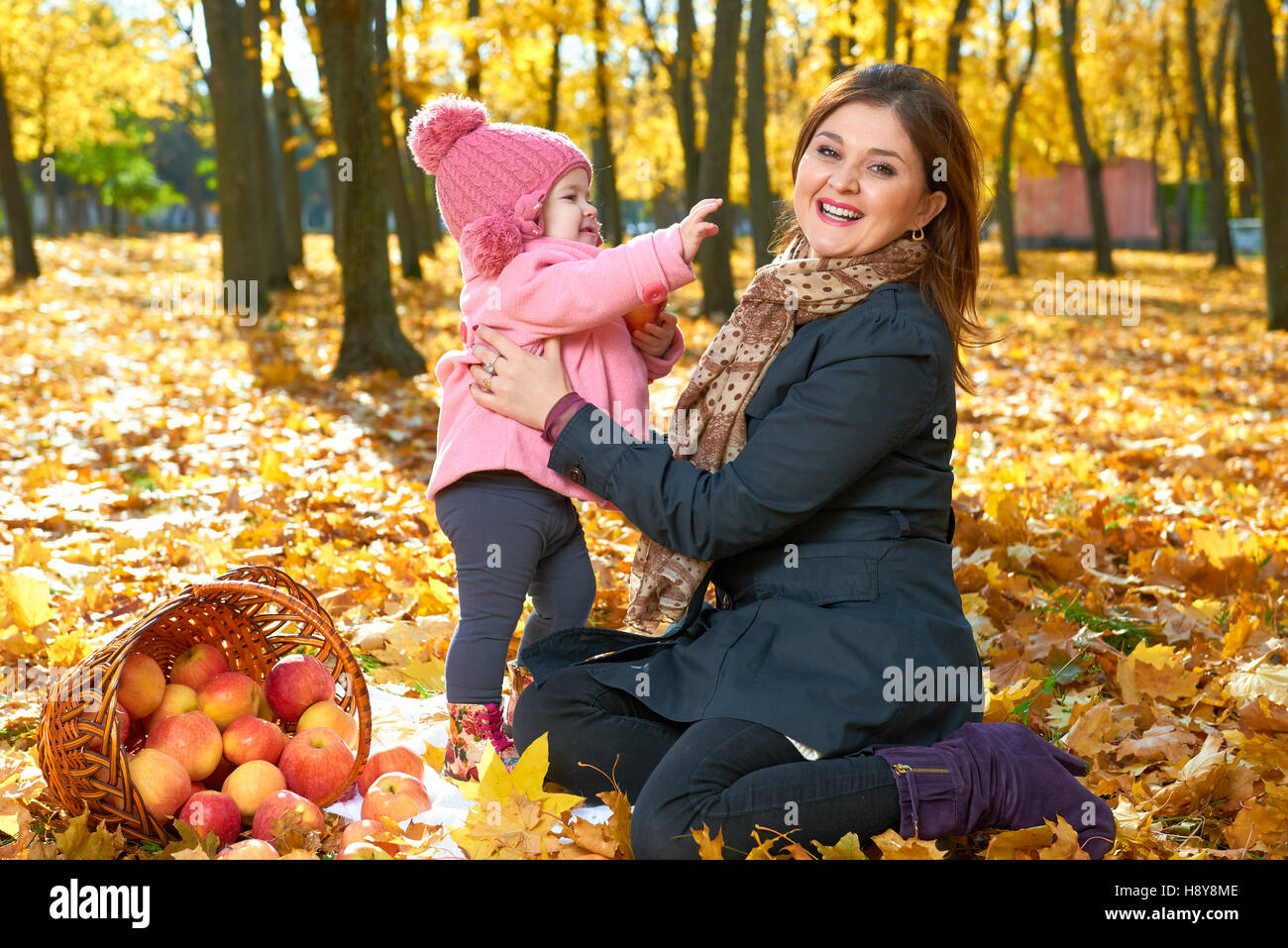 Woman with child girl in autumn city park, happy family Stock Photo - Alamy