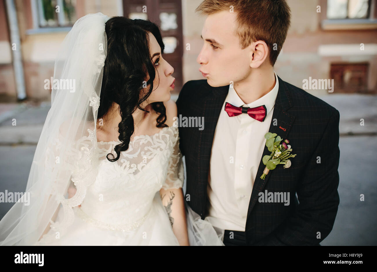 bride and groom posing on the streets Stock Photo - Alamy
