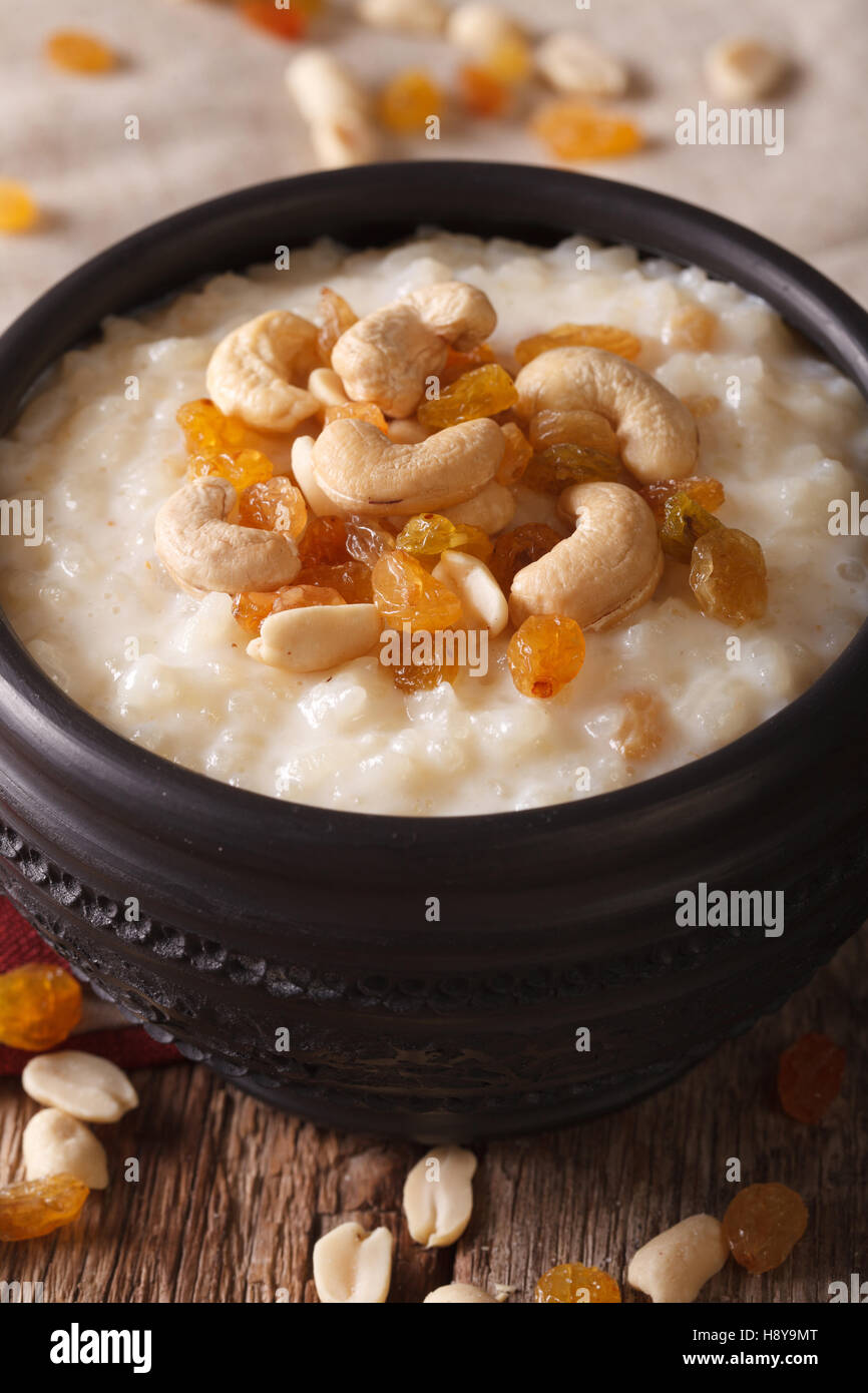 Indian kheer sweet rice pudding with nuts in a bowl macro. vertical ...