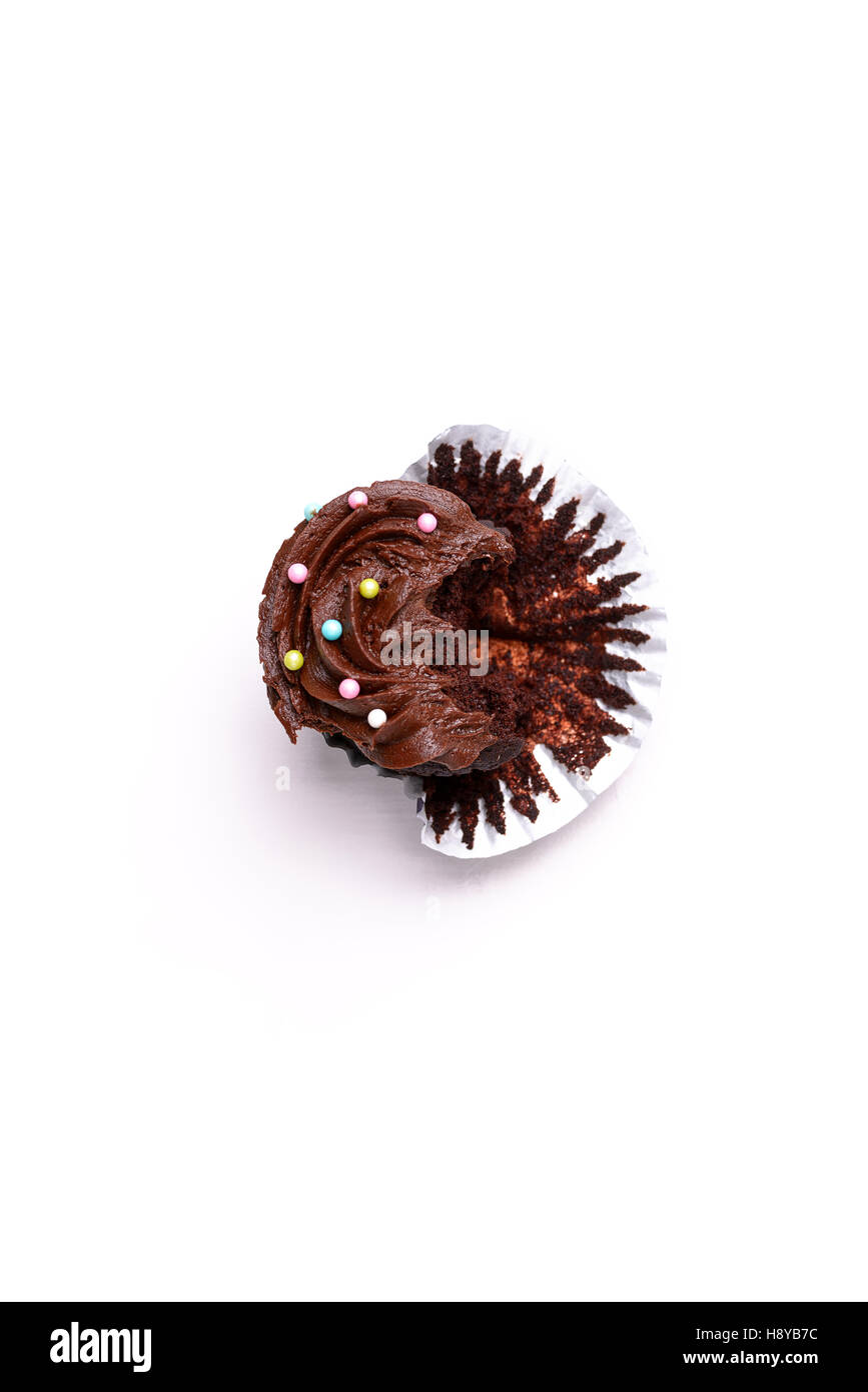 Delicious chocolat fairy cake bitten into, isolated on white background Stock Photo