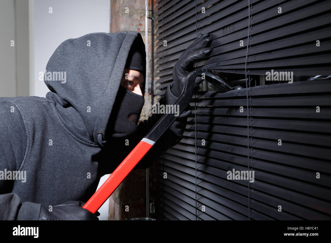 Thief trying to open window Stock Photo - Alamy