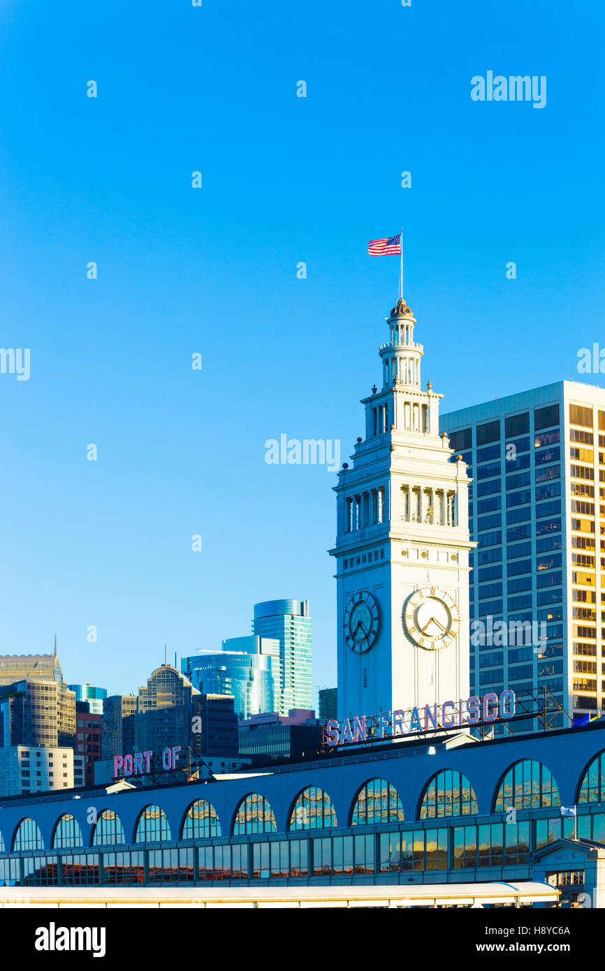 Office buildings of the Financial District surround the Ferry Building and clock tower at the rear of the Ferry Building Stock Photo