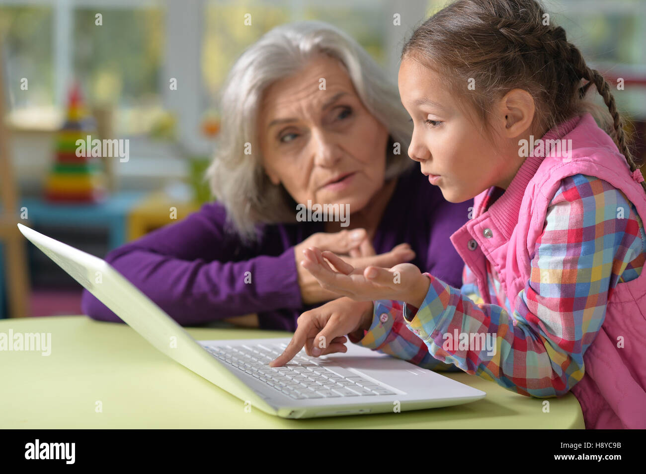 Grandmother and granddaughter with laptop Stock Photo - Alamy