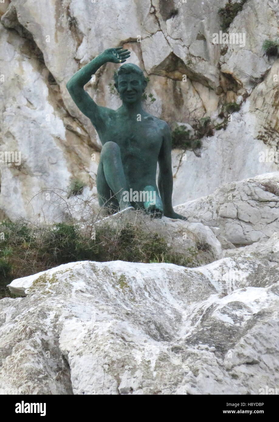 Local good luck statue on the rocks on Capri Stock Photo