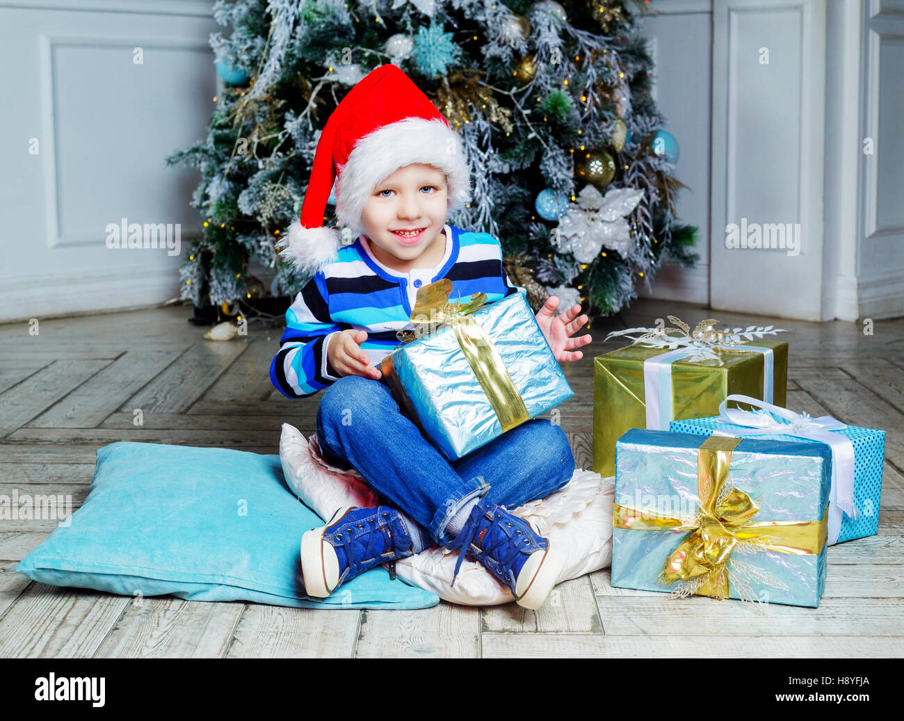 happy child at home with Christmas tree and presents Stock Photo Alamy