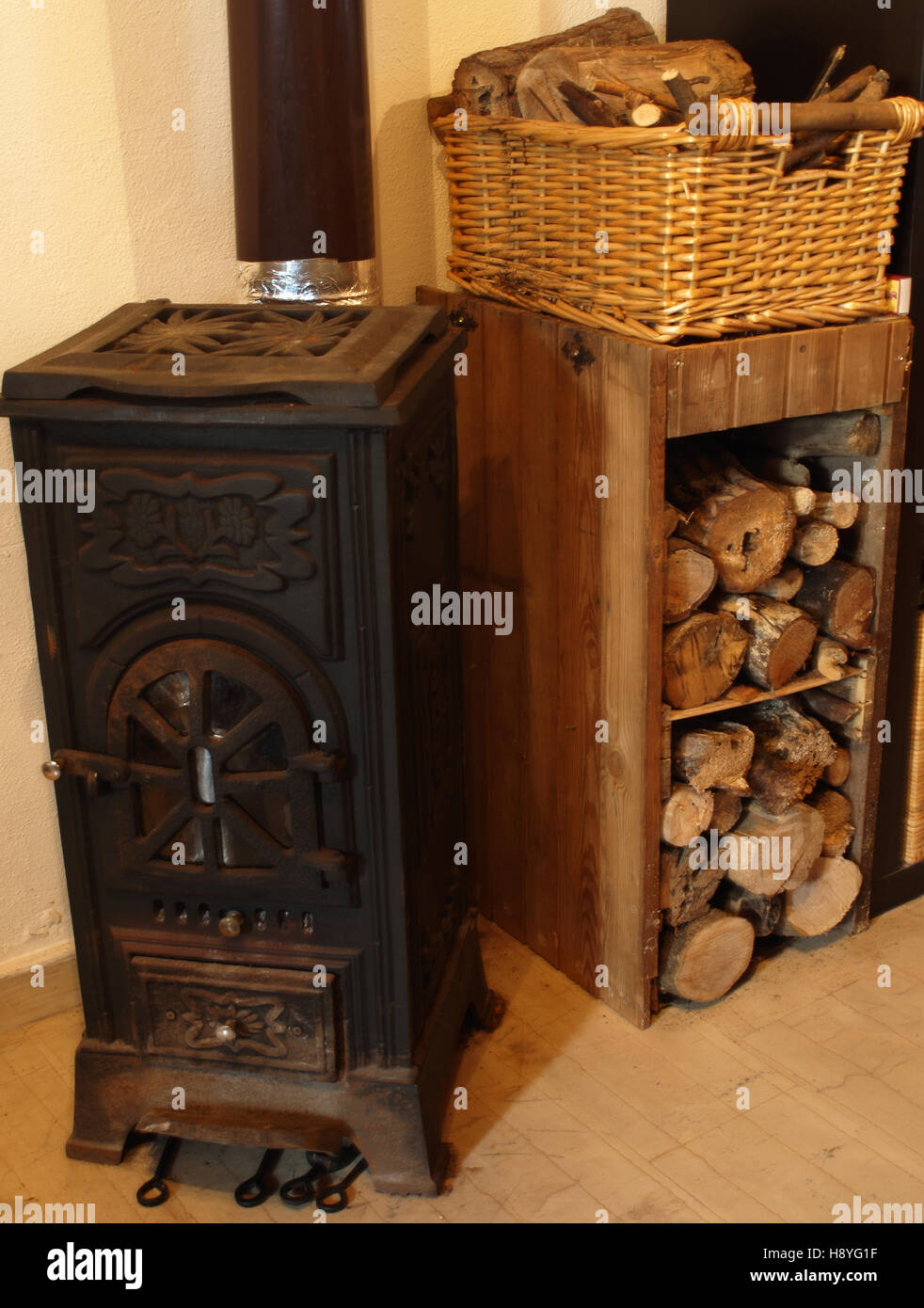 Wood burning stove with rustic log store Stock Photo Alamy