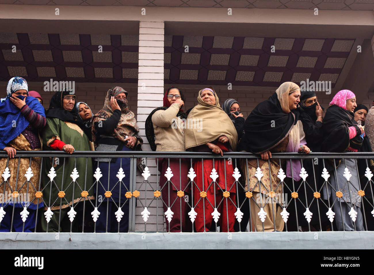 Amid tears, sobs, relatives and neighbors of Ghulam Mohammad Khan, watching his funeral procession while his body is being taken for burial in the outskirts of Srinagar, Indian Controlled Kashmir, on Thursday, November 17, 2016. Khan succumbed to his injuries early Thursday, after he was allegedly hit by a tear gas shell fired by Indian forces earlier this month during an anti-India protest. Stock Photo