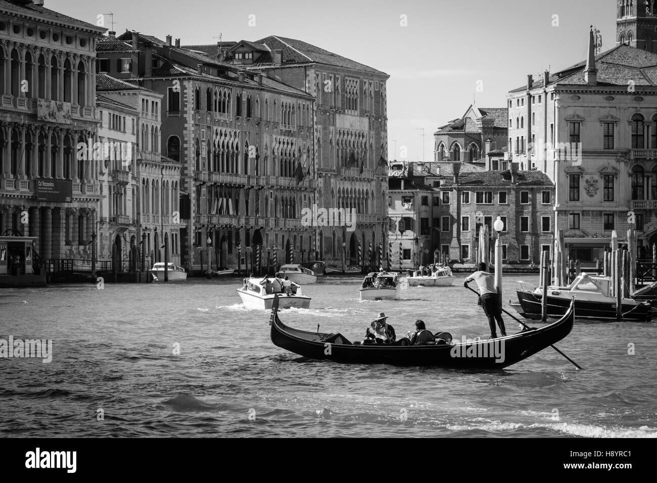A Gondola Sailing the Grand Canal in Venice, Italy Stock Photo