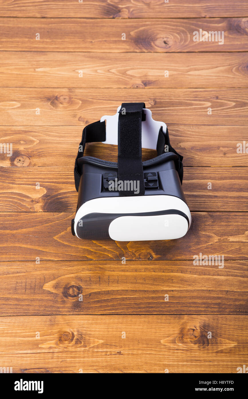 front side of a vr headset, isolated on wooden floor background Stock Photo