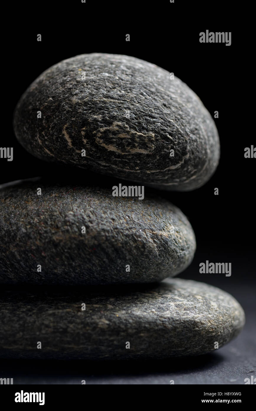 Pile of stones isolated on black background Stock Photo - Alamy