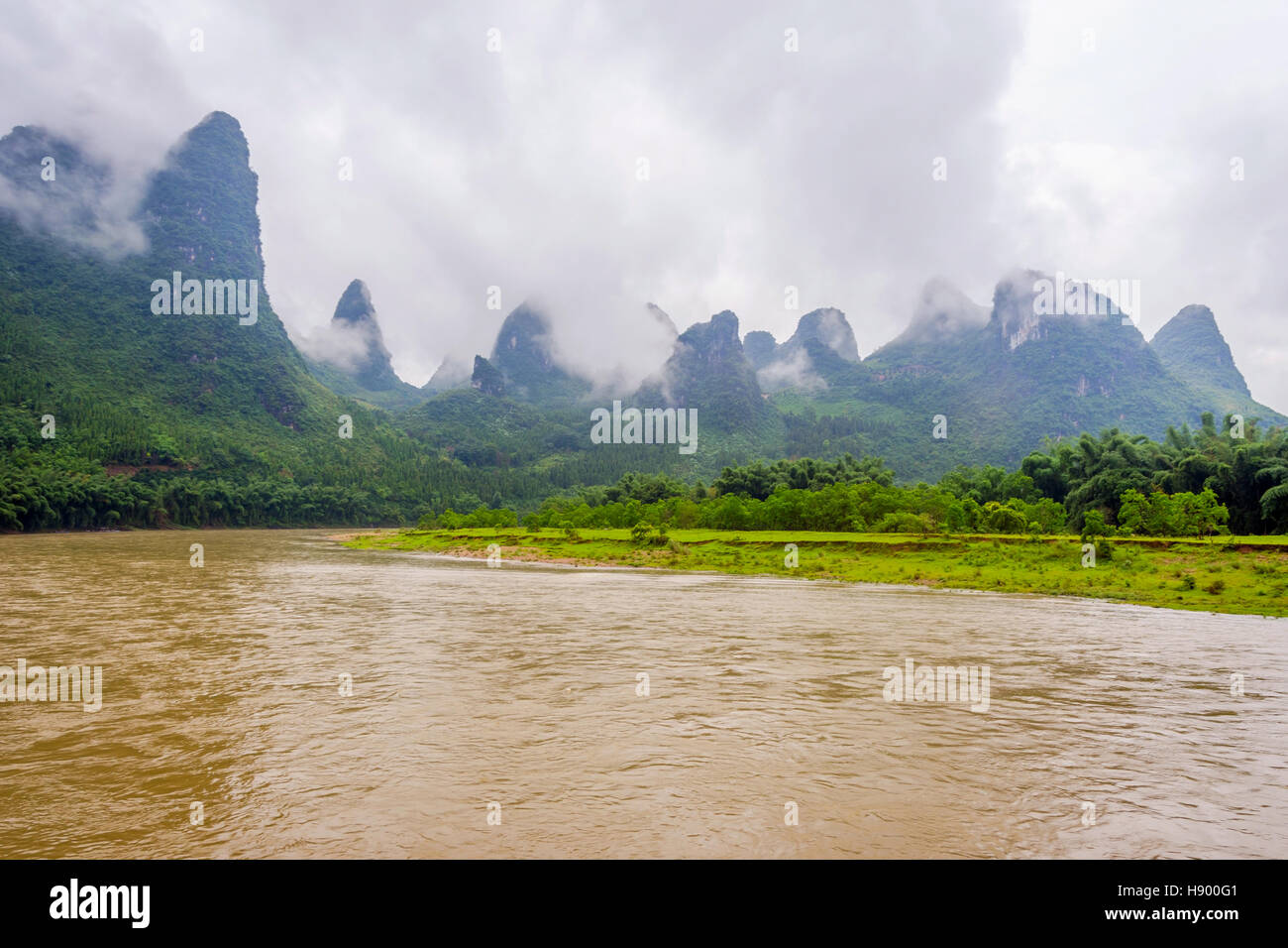 Li river with misty clouds and fog surrounded by famous karst mountains, Guangxi Zhuang, China Stock Photo