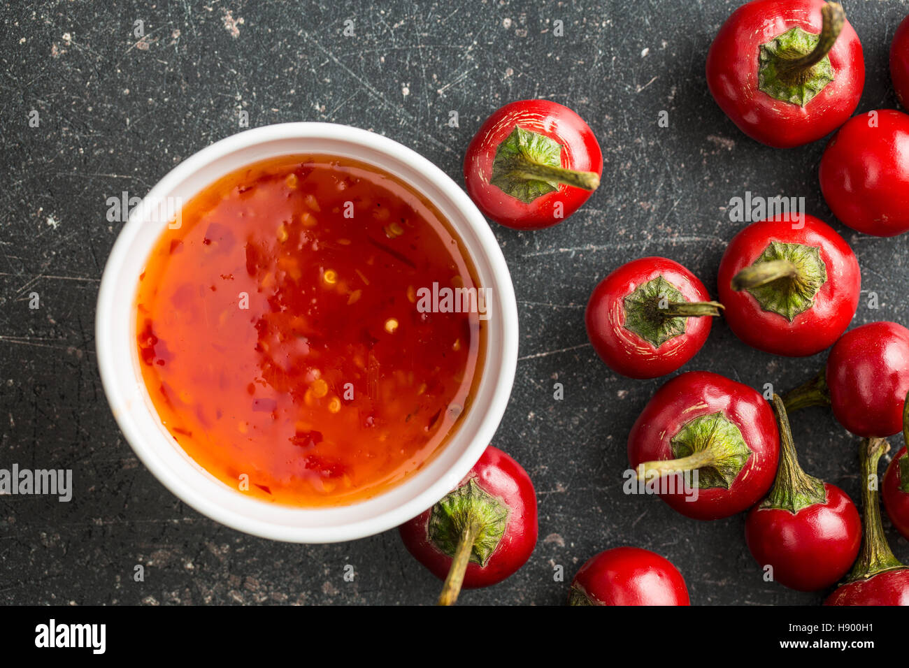 Red chili peppers and chili sauce. Top view. Stock Photo
