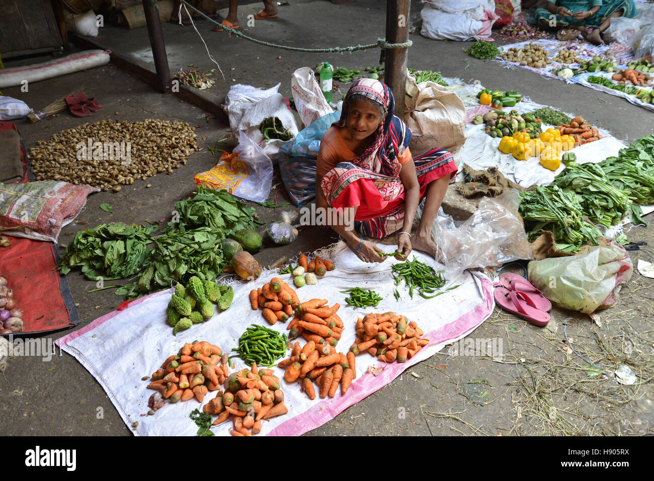 Dhaka, Bangladesh. 17th November 2016. A Bangladeshi Woman vegetable vendors wait for customer at Karwan Bazar kitchen market in Dhaka, Bangladesh.  Karwan Bazar is one of the largest wholesale Kitchen marketplaces in Dhaka city. It is also one of the largest Kitchen marketplaces in South Asia. As of 2002, the market had 1255 stores, out of which 55 were owned by the Dhaka City Corporation. In 2002, the wholesale market has a daily revenue of 50 million Bangladeshi taka. © Mamunur Rashid/Alamy Live News Stock Photo