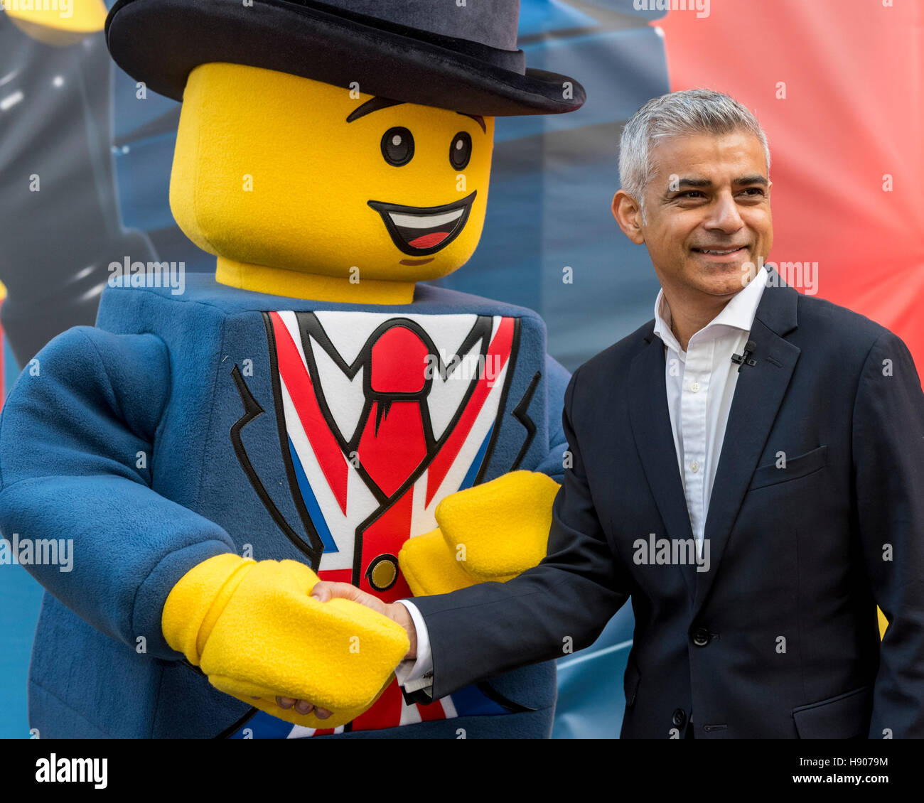 London, UK 17 November 2016. (L to R) Lego mascot, "Lester", and Sadiq  Khan. The world's largest Lego store is opened by Sadiq Khan, Mayor of  London, in Leicester Square. Huge crowds