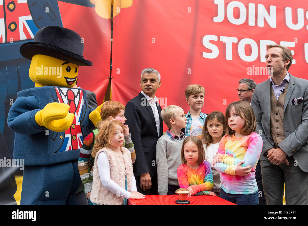 London, UK  17 November 2016. (L to R) Lego mascot, 'Lester', Sadiq Khan, local schoolchildren and Lego UK CFO. The world's largest Lego store is opened by Sadiq Khan, Mayor of London, in Leicester Square.  Huge crowds gathered for the opening and many Lego fans were able to buy exclusive pieces.  Credit:  Stephen Chung / Alamy Live News Stock Photo
